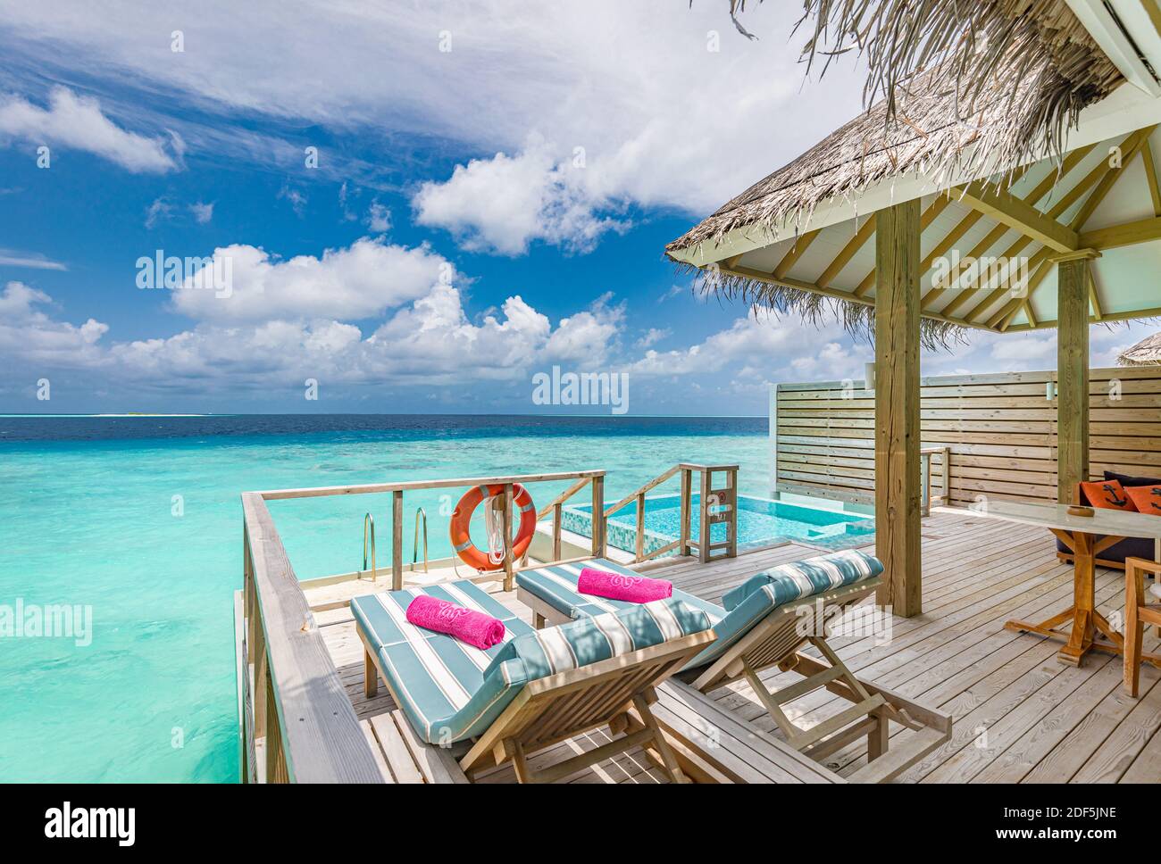 Fantastic over water villa, terrace view with sun beds chairs under