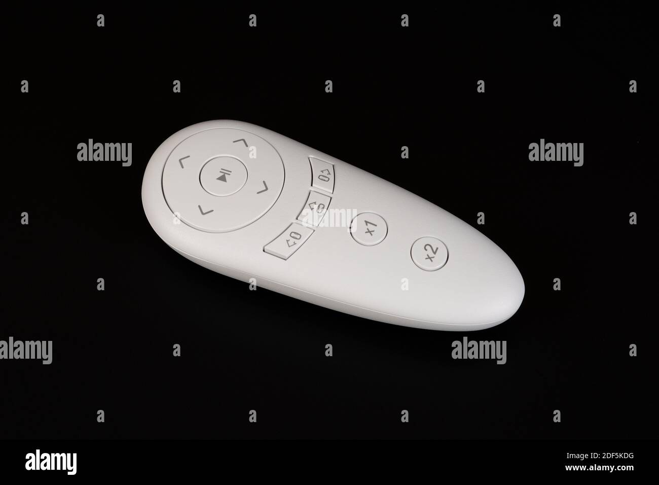 White remote control of windows cleaning robot on black background