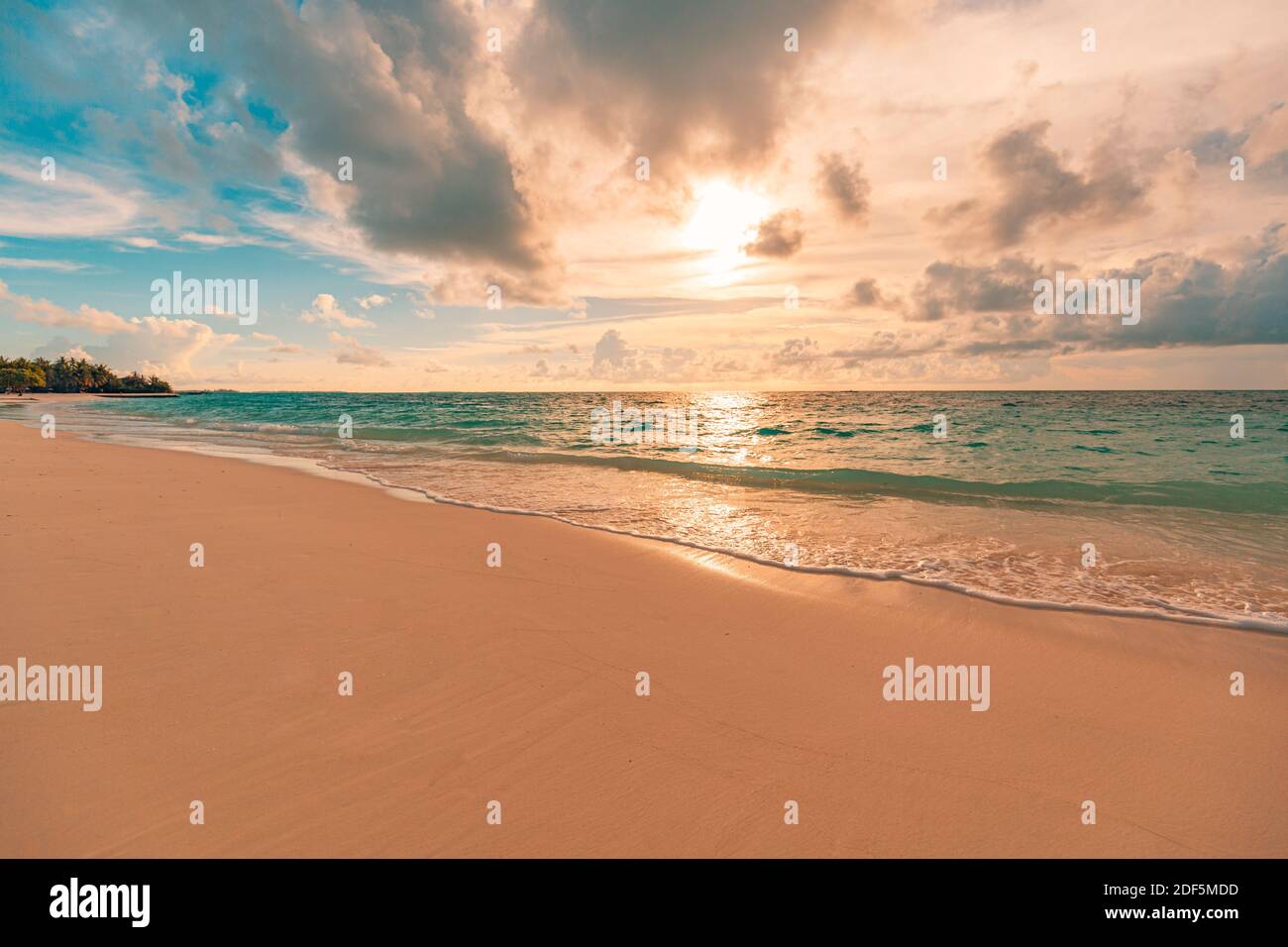 Closeup of sand on beach and blue summer sky. Beach landscape. Empty tropical beach and seascape. Orange and golden sunset sky, soft sand tranquil Stock Photo