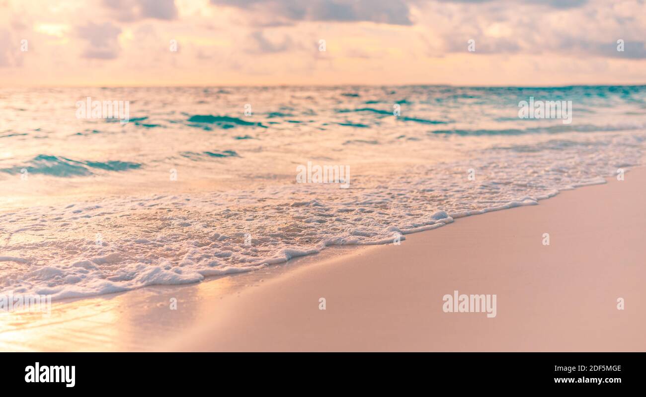 Closeup of sand on beach and blue summer sky. Beach landscape. Empty tropical beach and seascape. Orange and golden sunset sky, soft sand tranquil Stock Photo