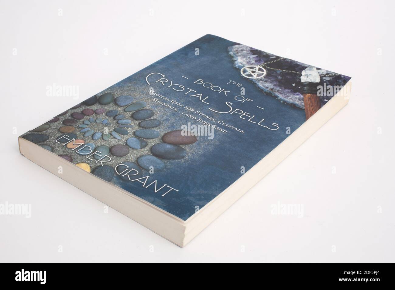 A studio photograph of the book, The book of crystal spells by Ember Grant Stock Photo