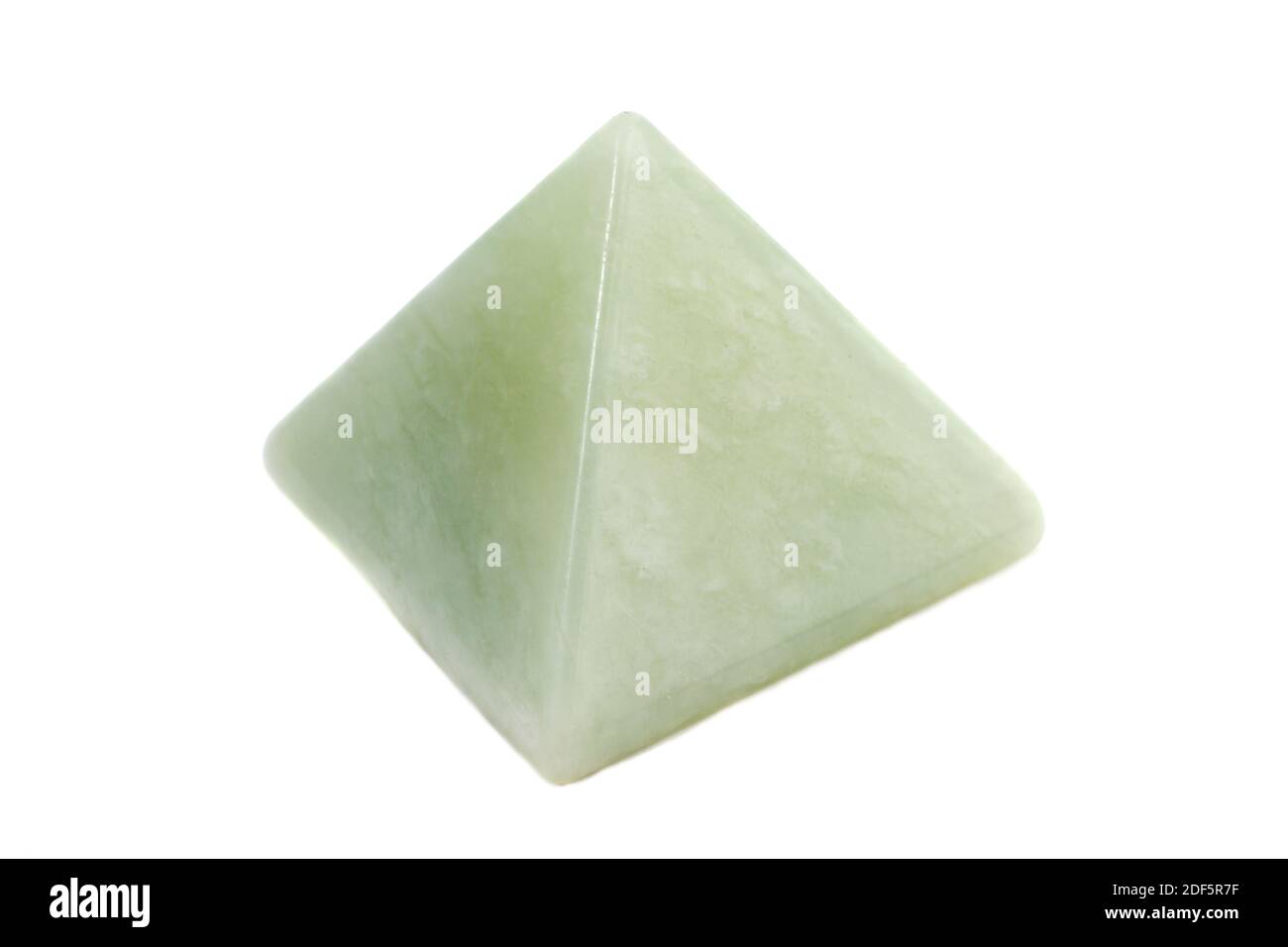 A jade pyramid photographed against a white studio background Stock Photo