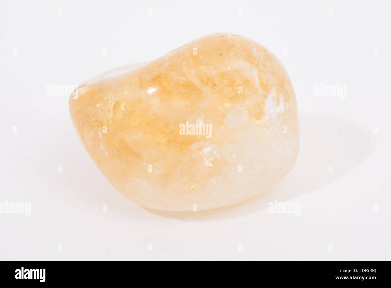 A citrine gemstone photographed against a white studio background Stock Photo