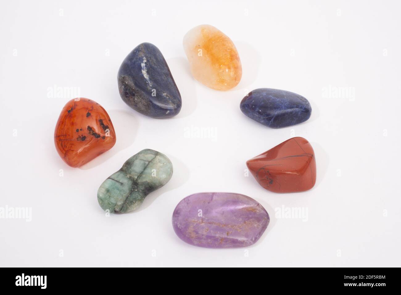 A mixture of different colorful gemstones shot against a white studio background Stock Photo