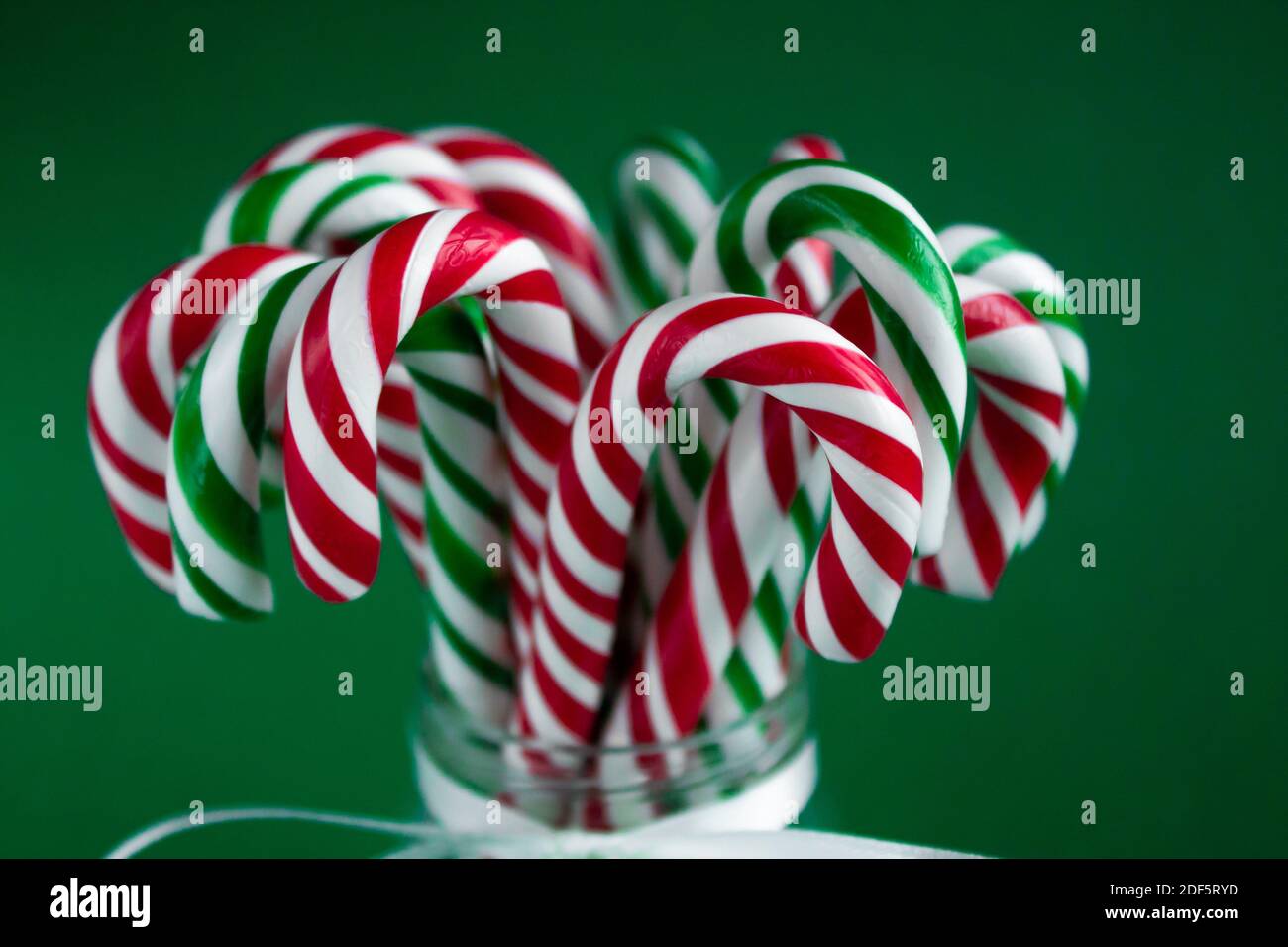 Candy canes close up. Christmas background. Green and red sweet sticks