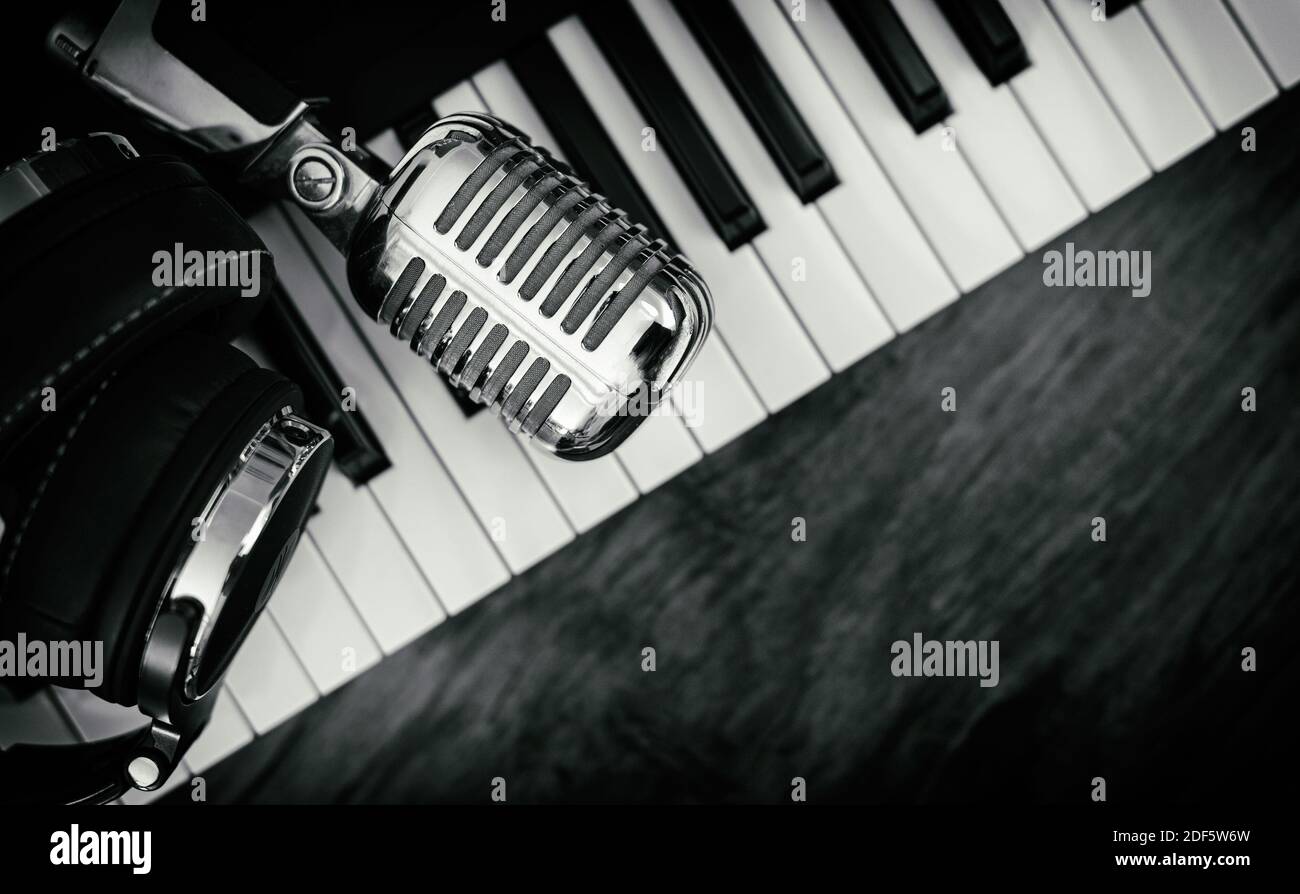 Headphones and microphone on the piano keyboard. Recording studio concept  Stock Photo - Alamy
