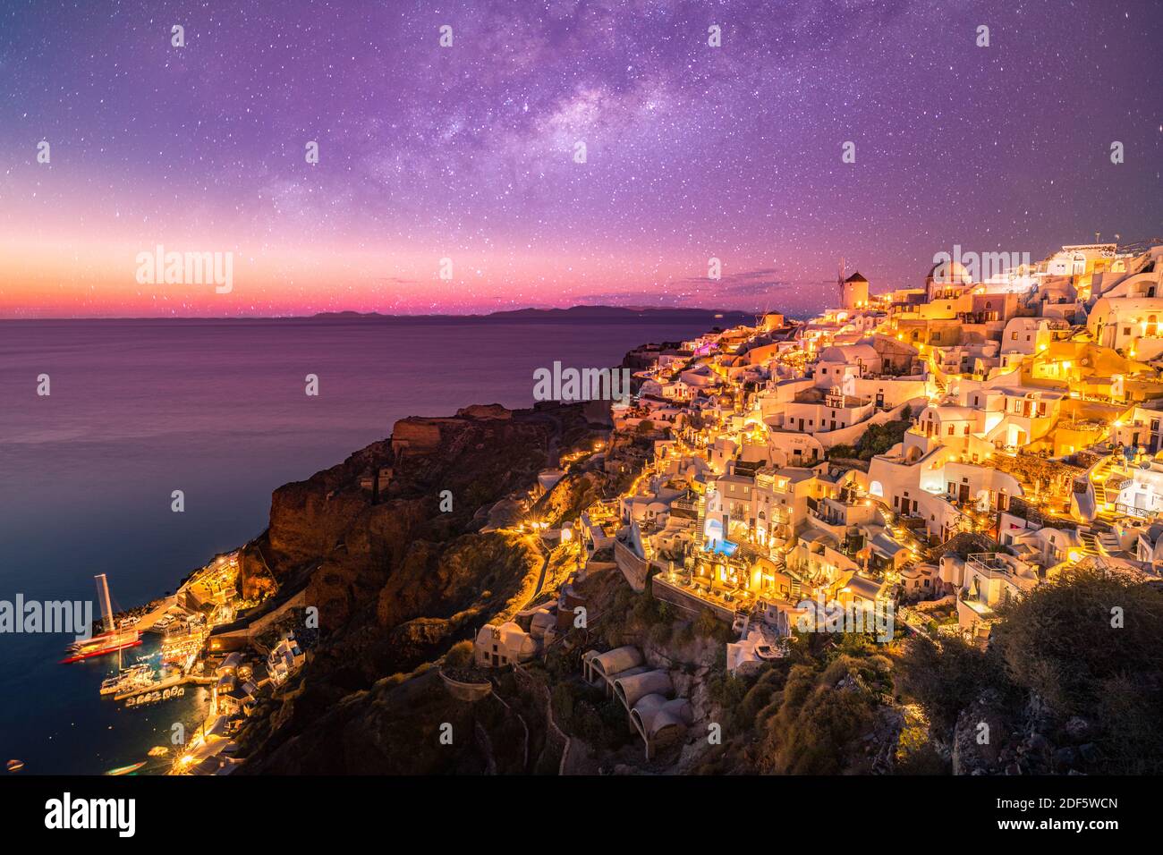 Amazing evening view of Santorini island. Picturesque spring sunset on the famous Fira village, Greece, Europe. Traveling concept background. Artistic Stock Photo