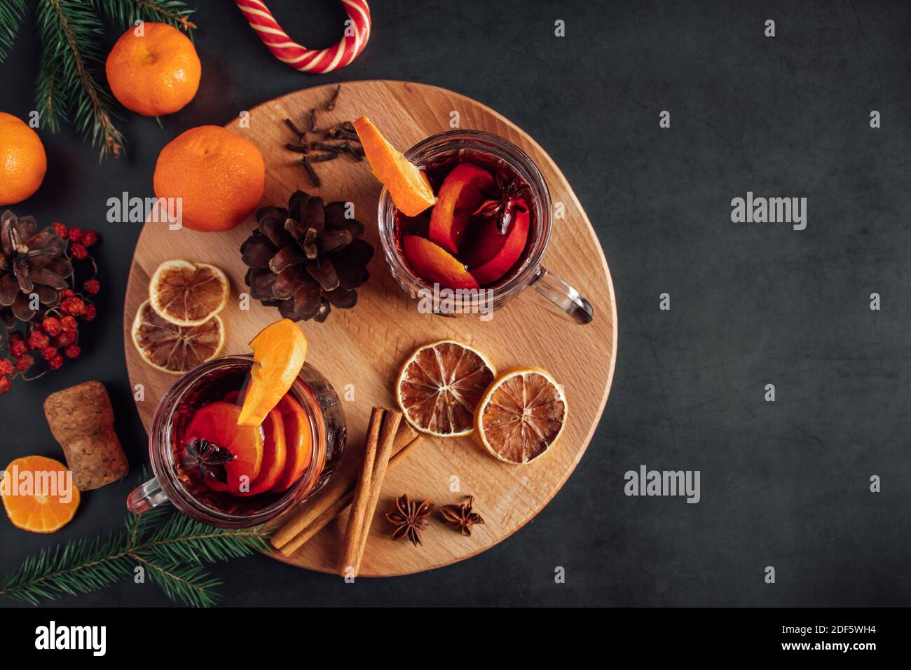 Hot mulled wine in glass cup. Warm winter drink with spices and fruits. Stock Photo