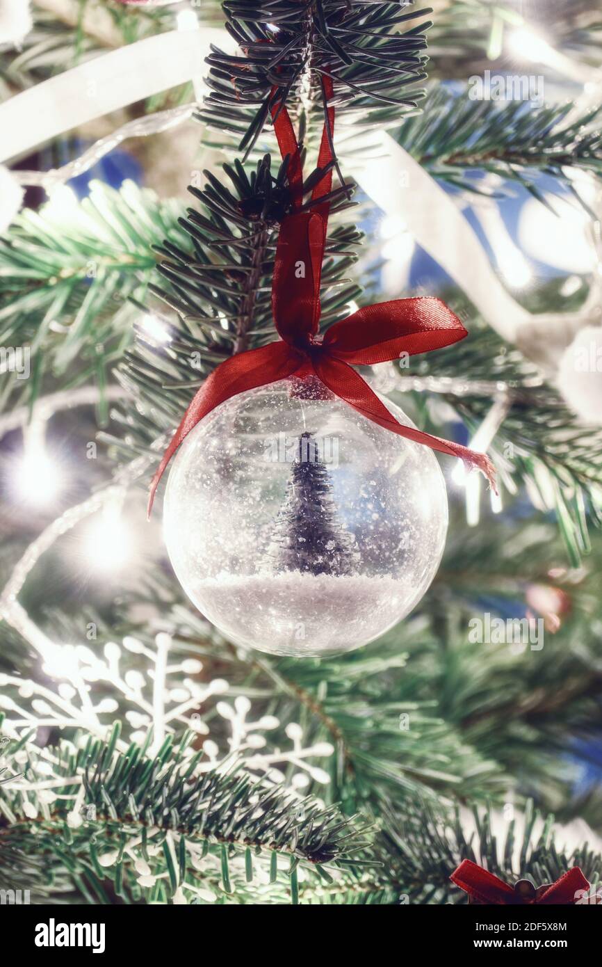 Lit christmas tree with spruce tree in snow bauble decoration Stock Photo