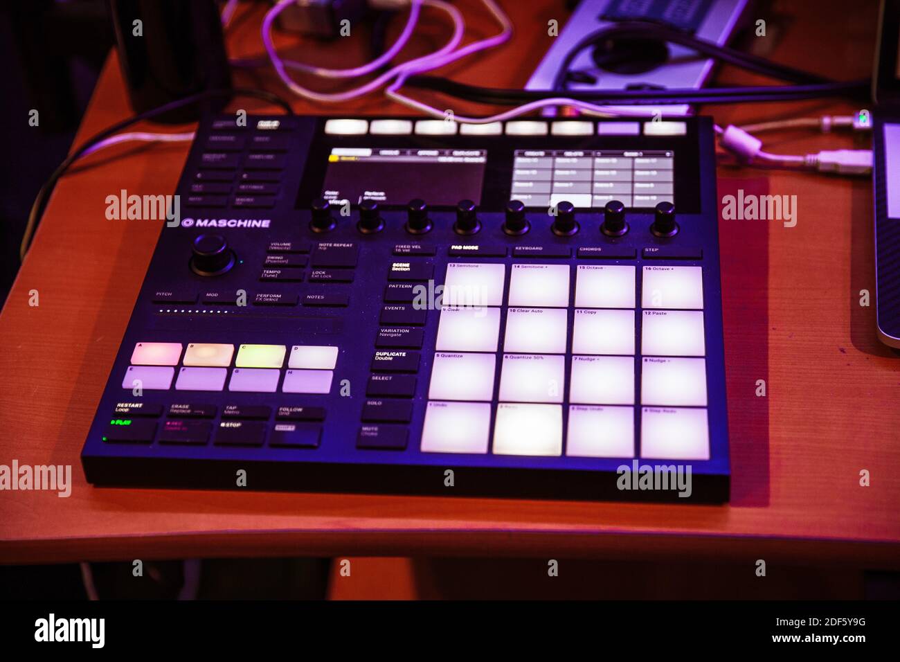 A closeup shot of a drum pad machine for beats and sound design on a wooden  table Stock Photo - Alamy