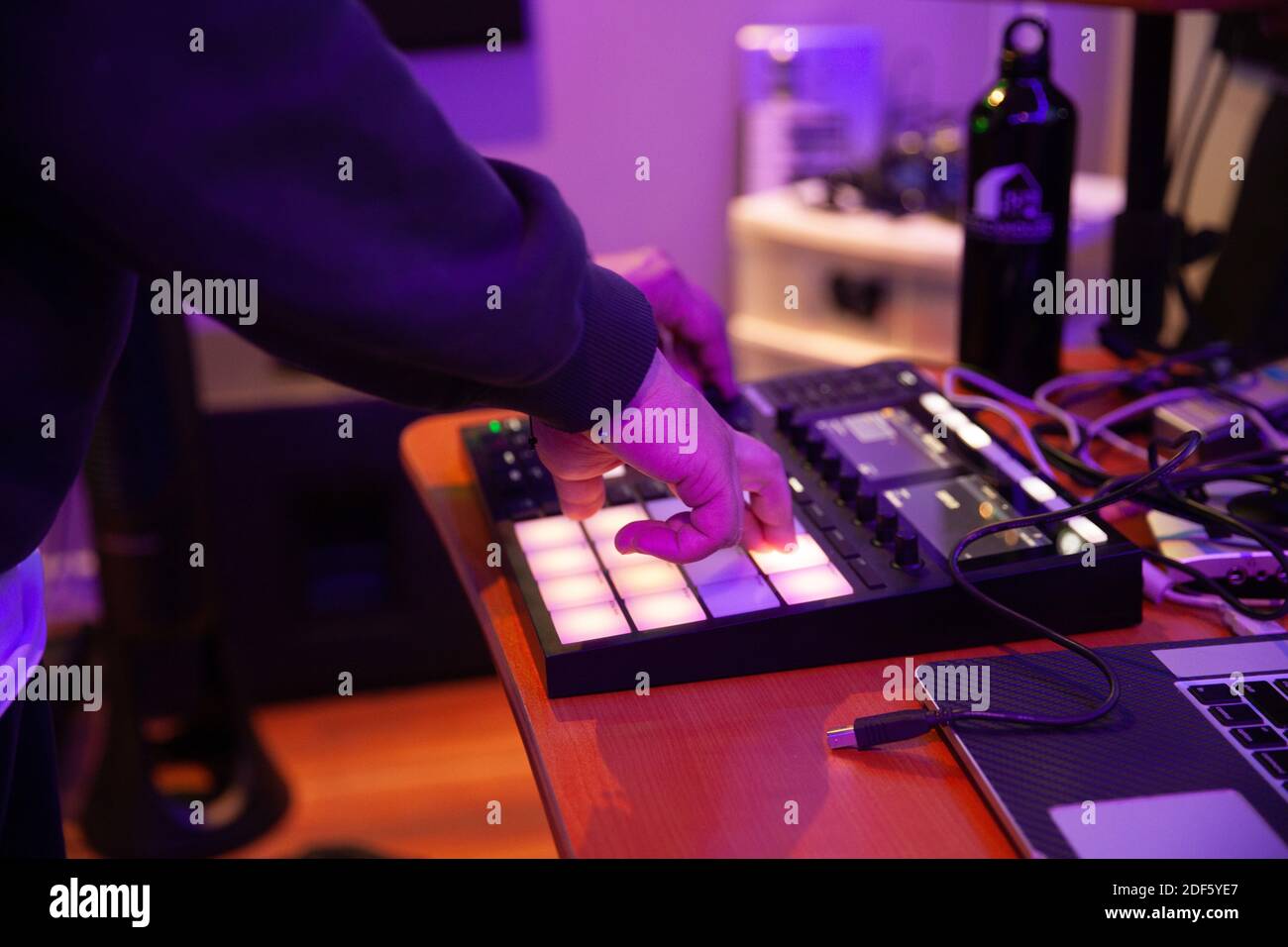 A closeup shot of a man making music beats and sounds with a drum pad  machine Stock Photo - Alamy