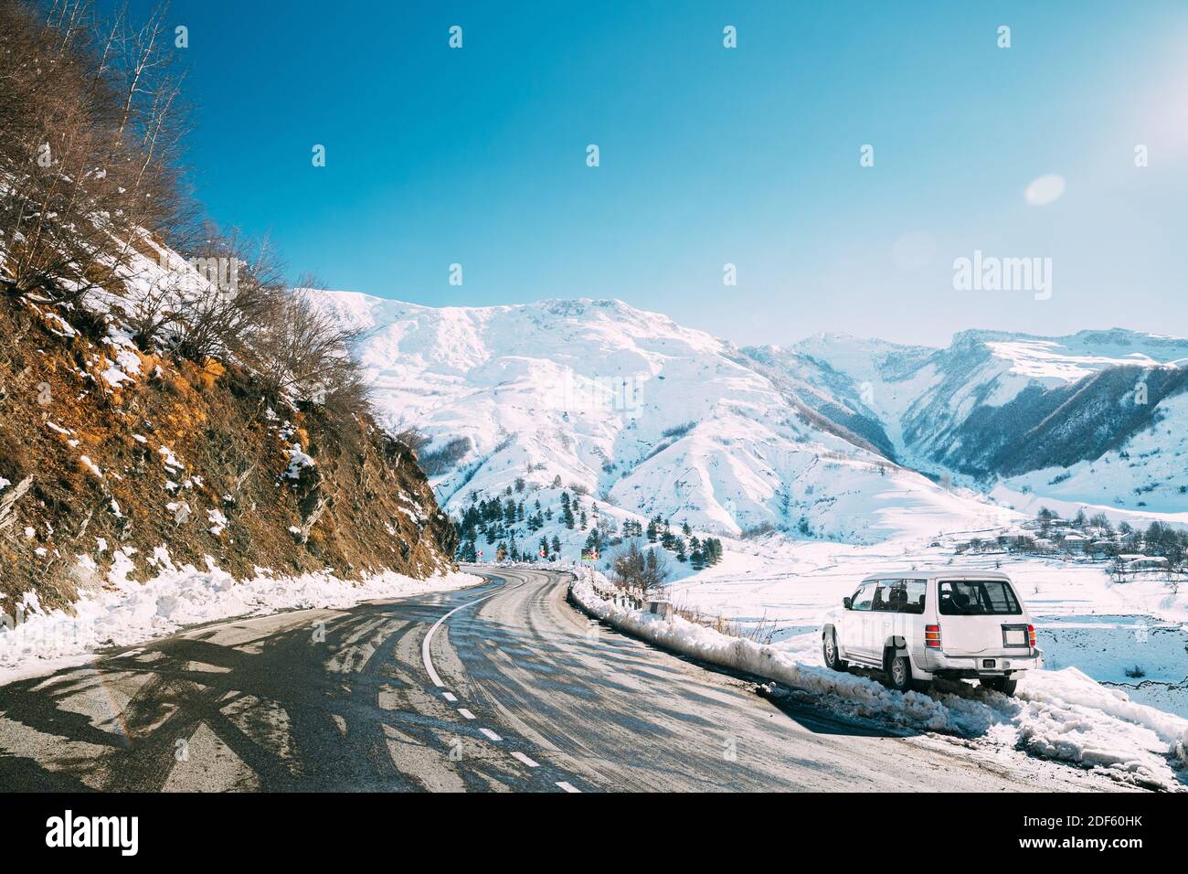 Zemo Mleta, Mtskheta-Mtianeti Region, Georgia. Car Parked On Roadside In Sunny Winter Day. Beautiful Georgian Mountains Landscape In Winter. Travel Stock Photo