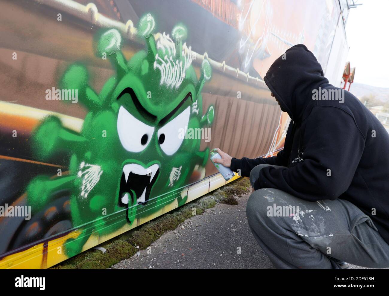 Artist David "S.I.D." Perez paints a graffiti, representing two vaccines  (Modernos 19 and Pizter Klorokinos) fighting against a virus in the  background of a popular video game Street Fighter, during the coronavirus