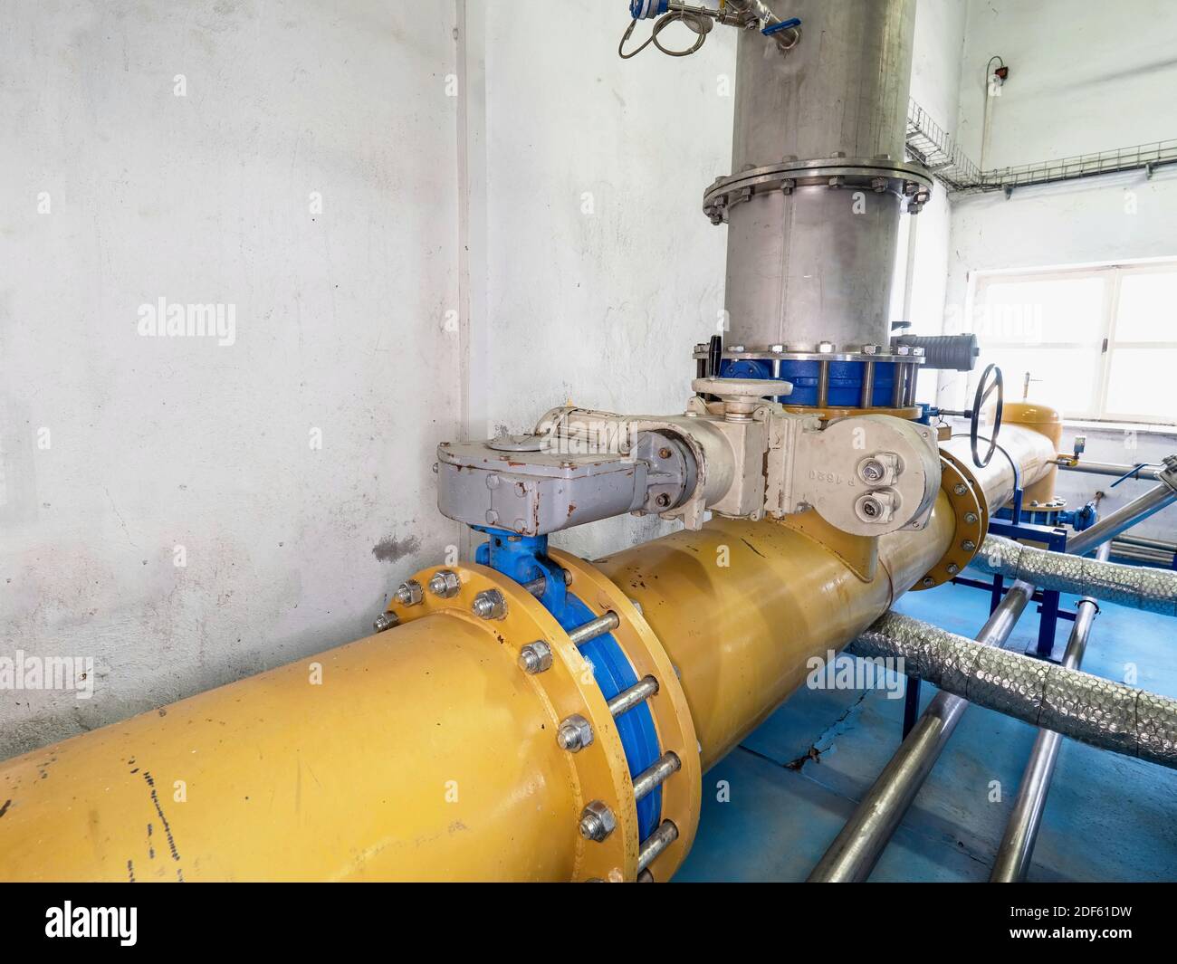 Separate room with large yellow gas tube with remote control valve and