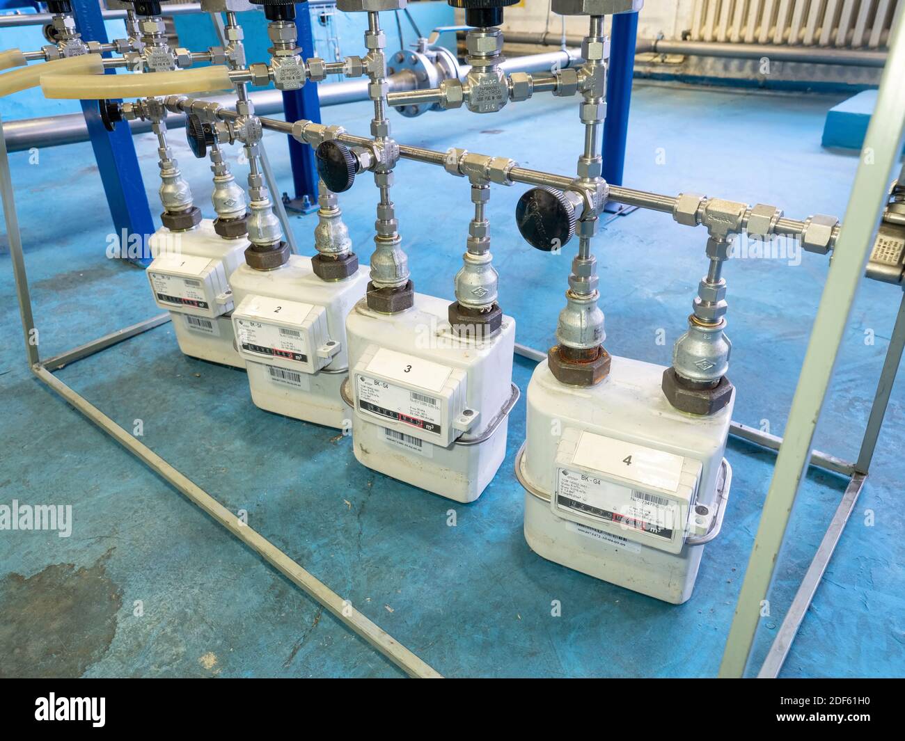 Worker checks methane gas consumption on gas flow meters. Industrial