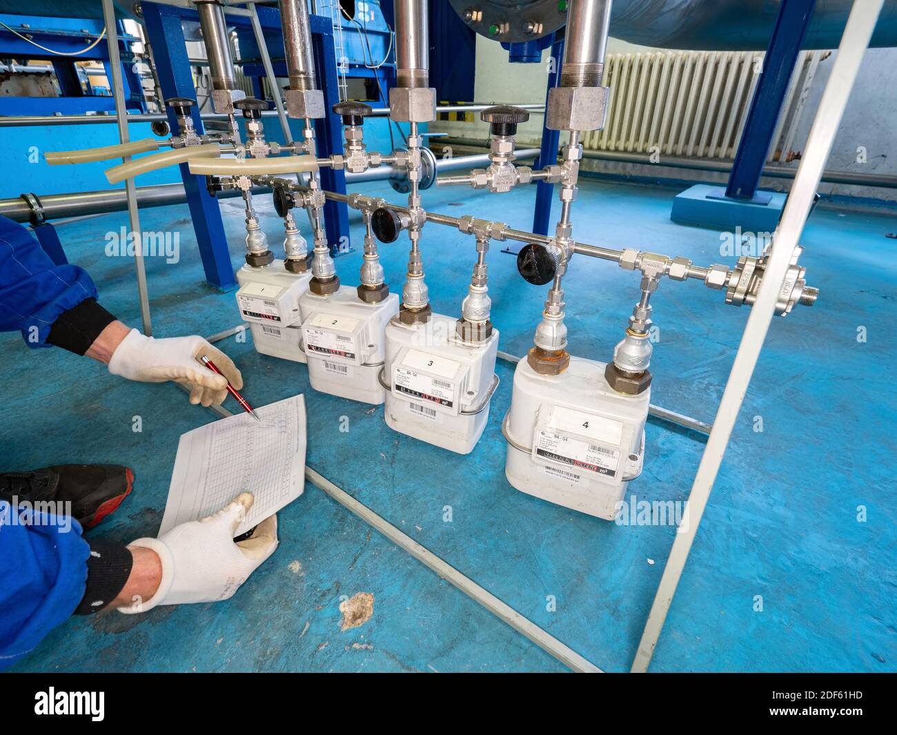 Worker checks methane gas consumption on gas flow meters. Industrial