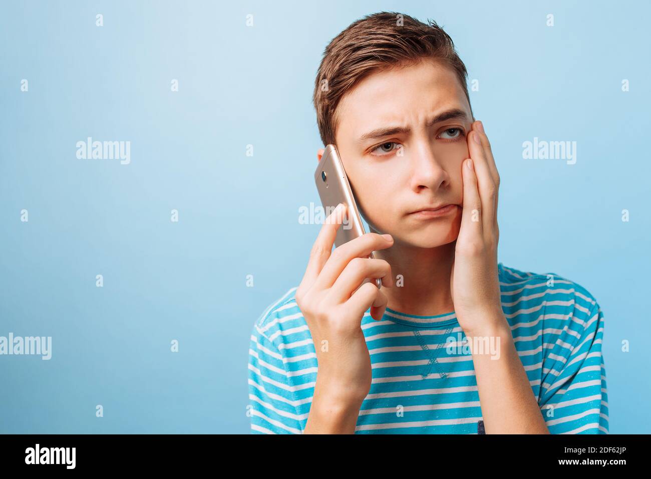the guy is talking on the phone, upset by what he heard Stock Photo