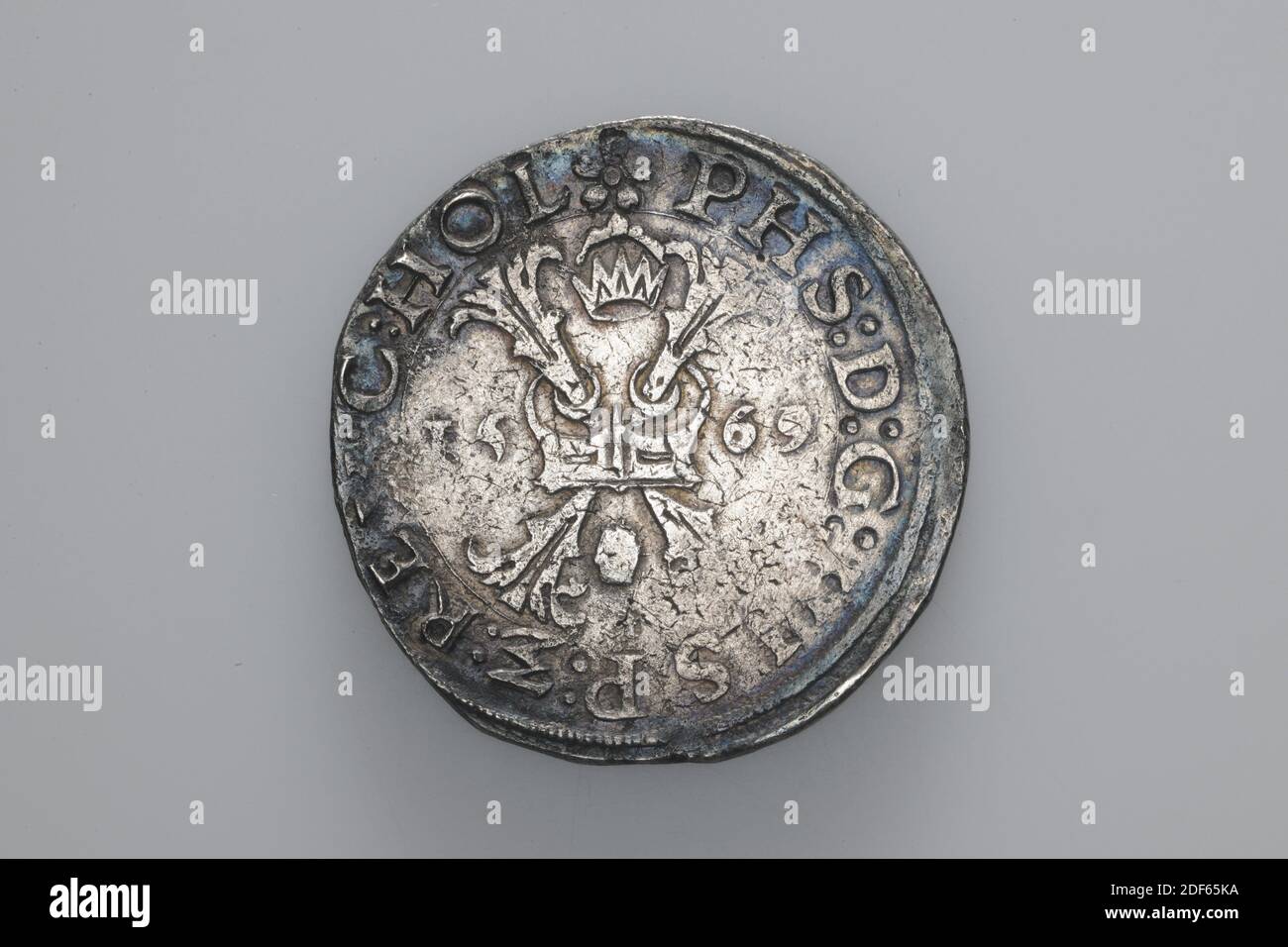 coin swap, Anonymous, 1569, minted, General: 3.8 x 0.2cm 38 x 2mm, Weight: 28.1g, weapon sign, cross, Silver coin of King Philips II, minted in 1569. On the obverse is a central Burgundian cross depicted. The year 1569 is written on both sides. Around it is the circular PHS D G HISP REX [worn] C HOL. On the reverse is a crowned coat of arms with the chain of the Golden Fleece around it, with the sheepskin hanging at the bottom. It is surrounded by the circular DOMINUS MI HI ACIVIOR, 1926 Stock Photo