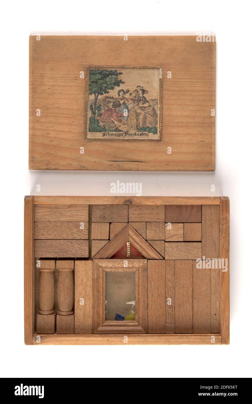 kit, Anonymous, c. 1850, glass, oak, General: 3.5 x 19.3 x 14cm 35 x 193 x 140mm, Schweizer Baukasten. Box with 26 oak building elements such as beams, blocks, two columns, a window with glass and a tympanum. An engraving is pasted on the sliding lid of the box. This engraving represents a landscape with three figures; two children and a wife. One of the children is playing with the construction kit. On the inside of the lid, in ink, is a drawing of the various building blocks with numbers. Furthermore, the name François can be recognized in blue pencil next to the inscription: 'Forbidden Stock Photo