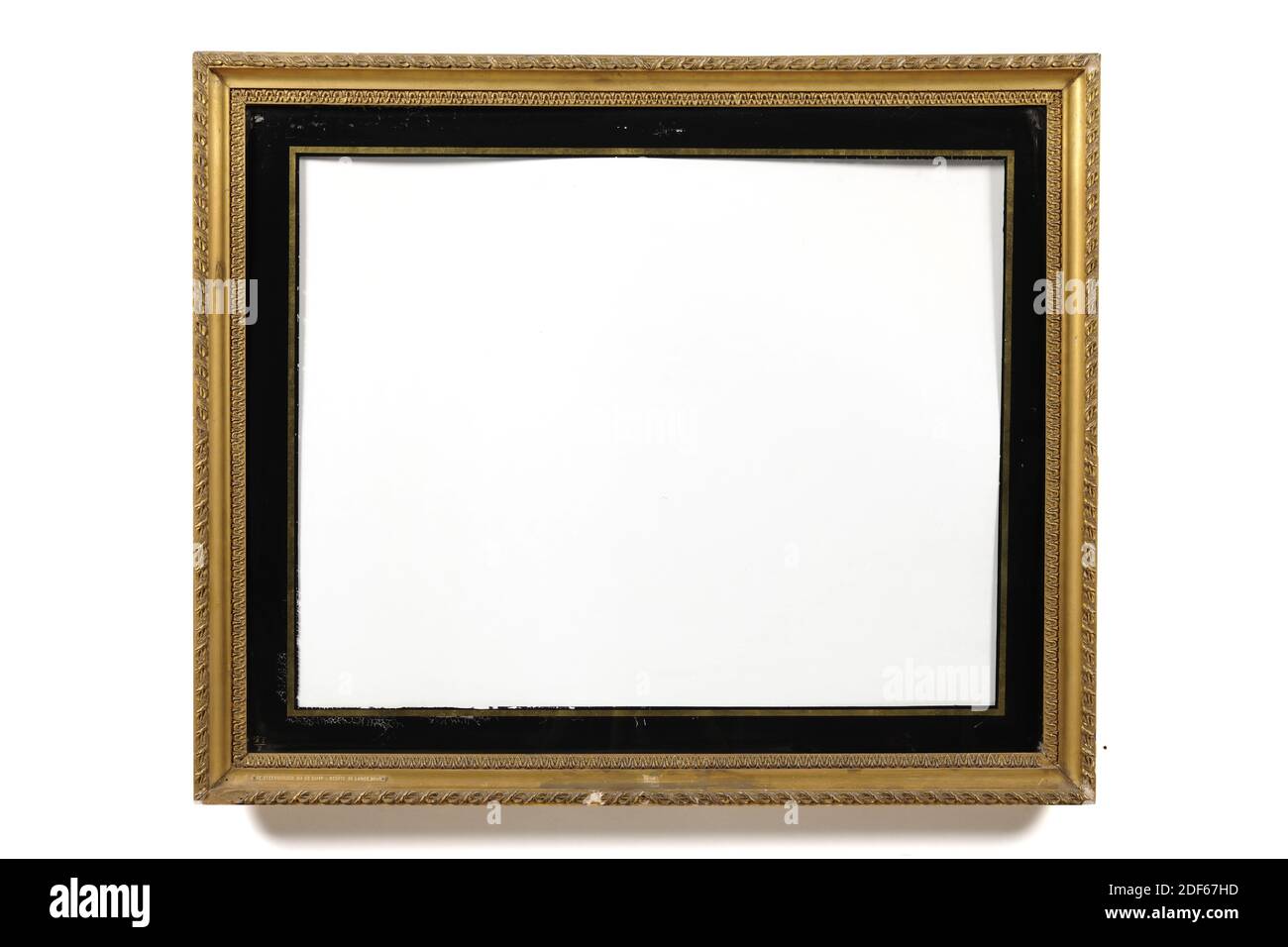 picture frame, Anonymous, after 1807, glass, plaster, gilding, wood, gilded, General: 77.5 x 92.2 x 4cm (775 x 922 x 40mm), Inner size: 69 x 85cm (690 x 850mm), Day frame size: 67 x 82cm (670 x 820mm), Daylight passe-partout: 57.2 x 72.3cm (572 x 723mm), Hollow gilded picture frame with a tulip edge in the inner frame. A twisted rim with leaves on the crown. The frame has a receding outer wall. A black passe-partout is painted on the glass, with a narrow gold-colored rim, 1880 Stock Photo
