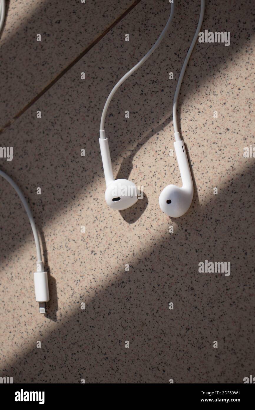 White earphones in the sun-light, left and right, apple earphones Stock Photo