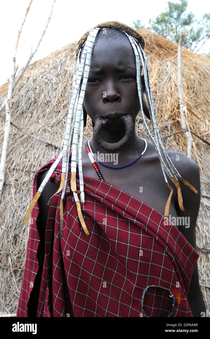 Mursi girl with her lip pierced by a typical mursi plate lip. Mursi or Mun people are animist and pastoralist and reside in Debub Omo Zone in the Stock Photo