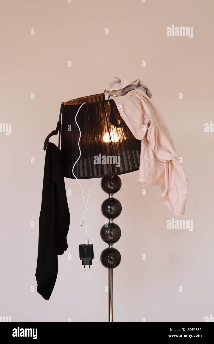 Clothes on the lamp, wardrobe mess Stock Photo