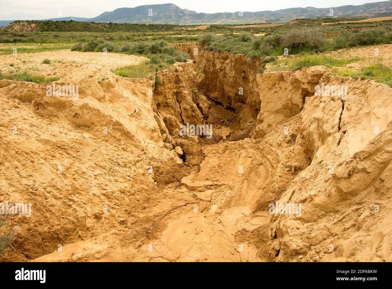 Wadi or rambla is an intermittent stream characteristic of arid climates. This photo was taken in Bardenas Reales, Navarra, Spain. Stock Photo