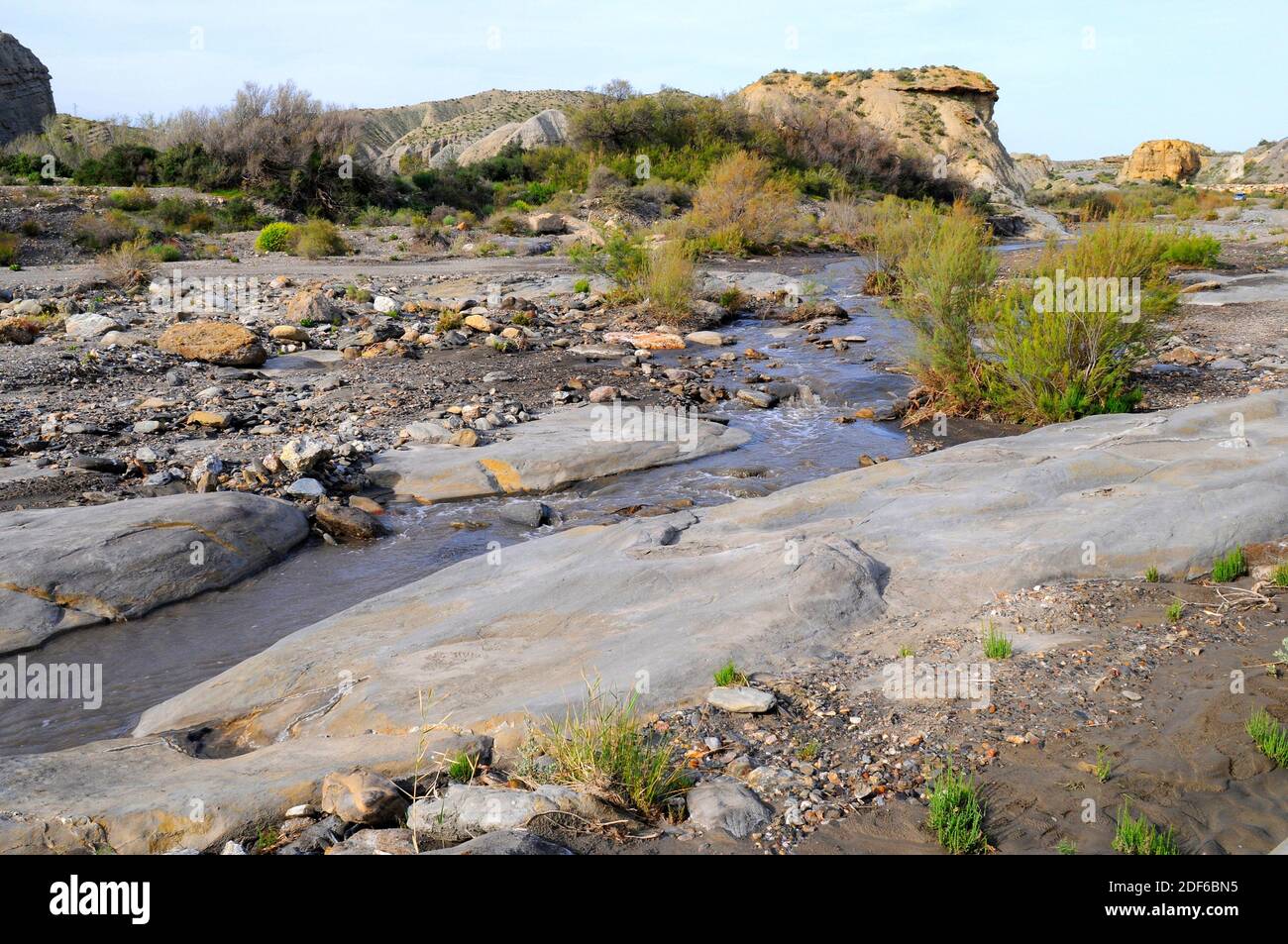 Wadi or rambla is an intermittent stream characteristic of arid climates. This photo was taken in Desierto de Tabernas, Almeria, Andalusia, Spain. Stock Photo