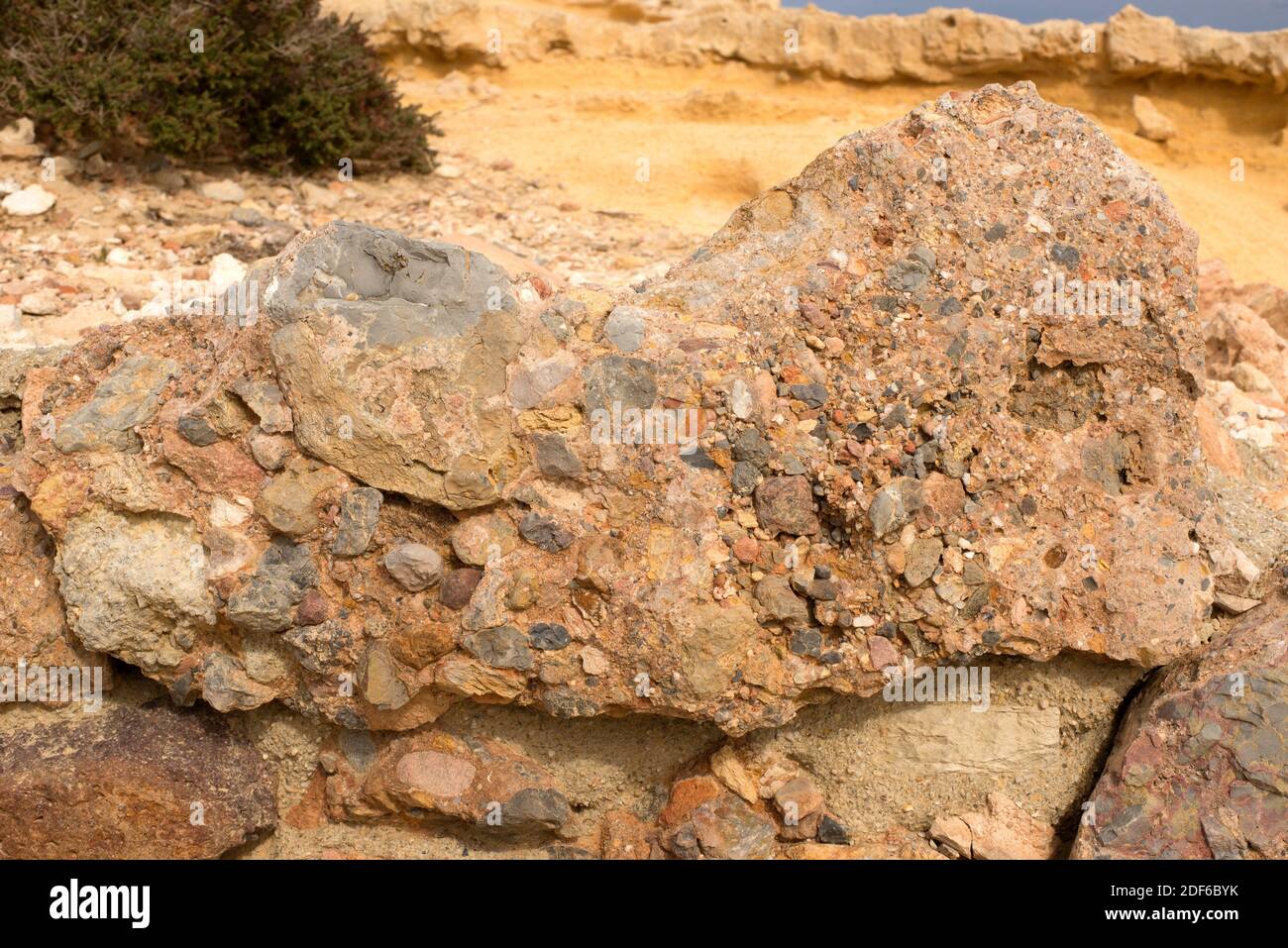 Conglomerate is a clastic sedimentary rock composed of rounded clasts (pudding stone). This sample comes from Cabo de Gata, Almeria, Andalusia, Spain. Stock Photo
