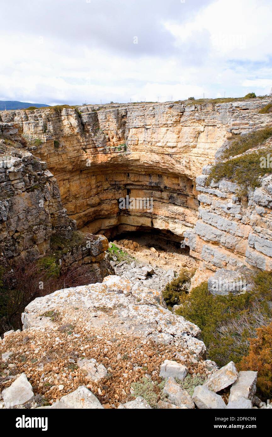 Sinkhole, cenote or sink is a hole produced by dissolution in karstic soils. Sima de Pozondon, Sierra de Albarracin, Teruel, Aragon, Spain. Stock Photo