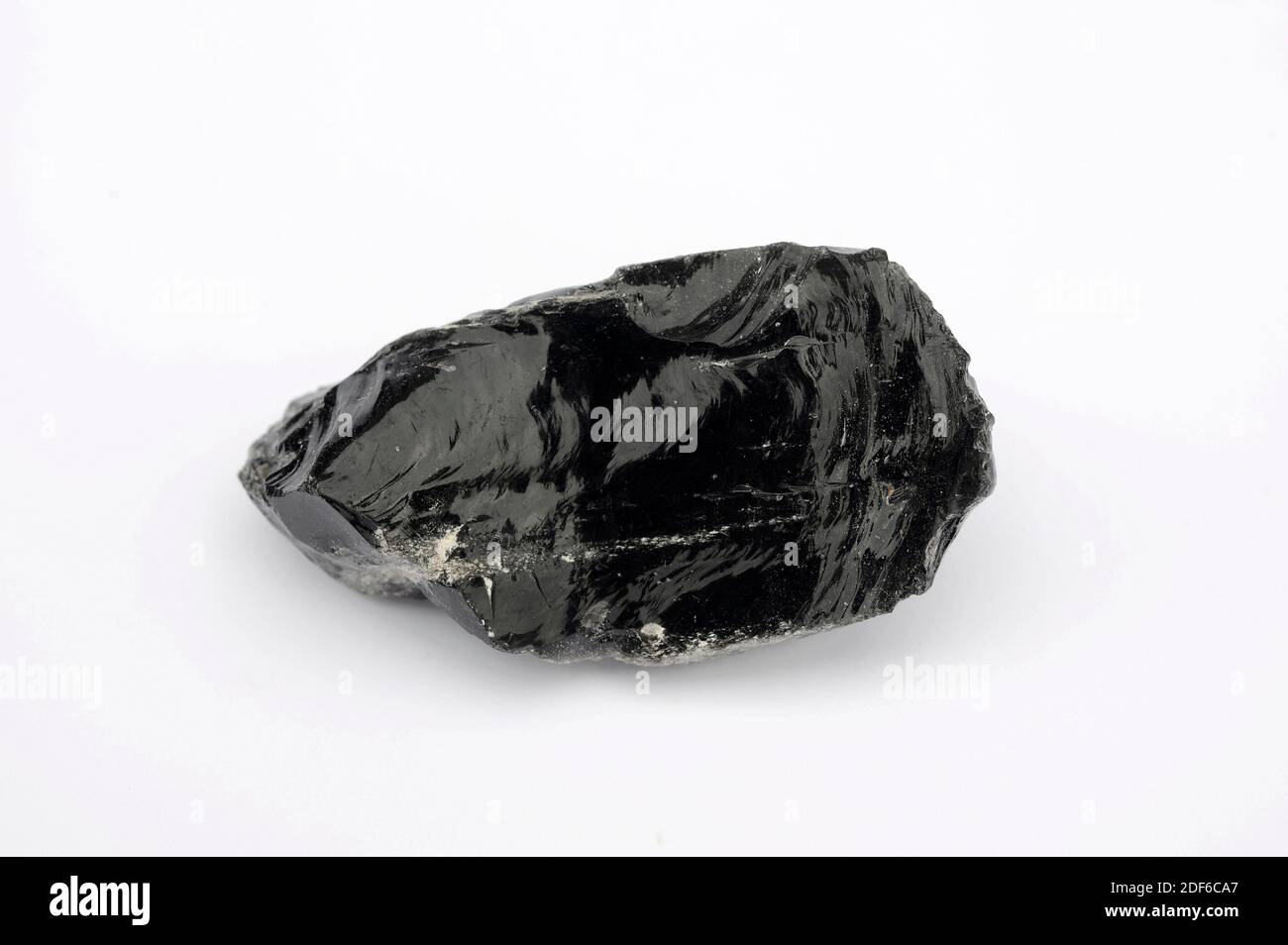 Obsidian is a volcanic glass rock with conchoidal fracture. This sample comes from Mexico. Stock Photo