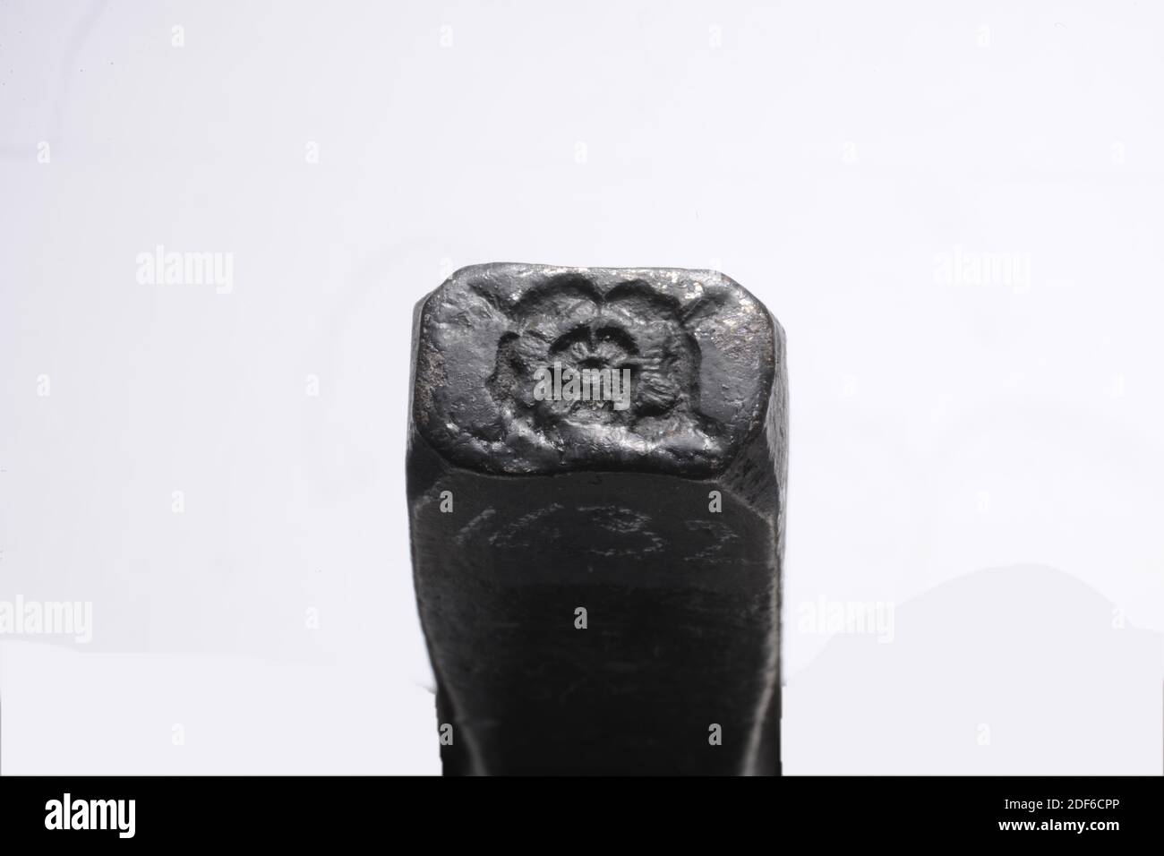 stamp (for cloth leads), Anonymous, 17th century-18th century, General: 13.4 x 2.2 x 1.8cm (134 x 22 x 18mm), Stamp: 1.1 x 1.8cm (11 x 18mm), rose, Iron stamp for sheet lead with the image of a rose. The stamp is rectangular elongated in shape with a slightly protruding top. The stamp reads 38 (above the line) and 1.79 (below the line), 1879 in white ink Stock Photo