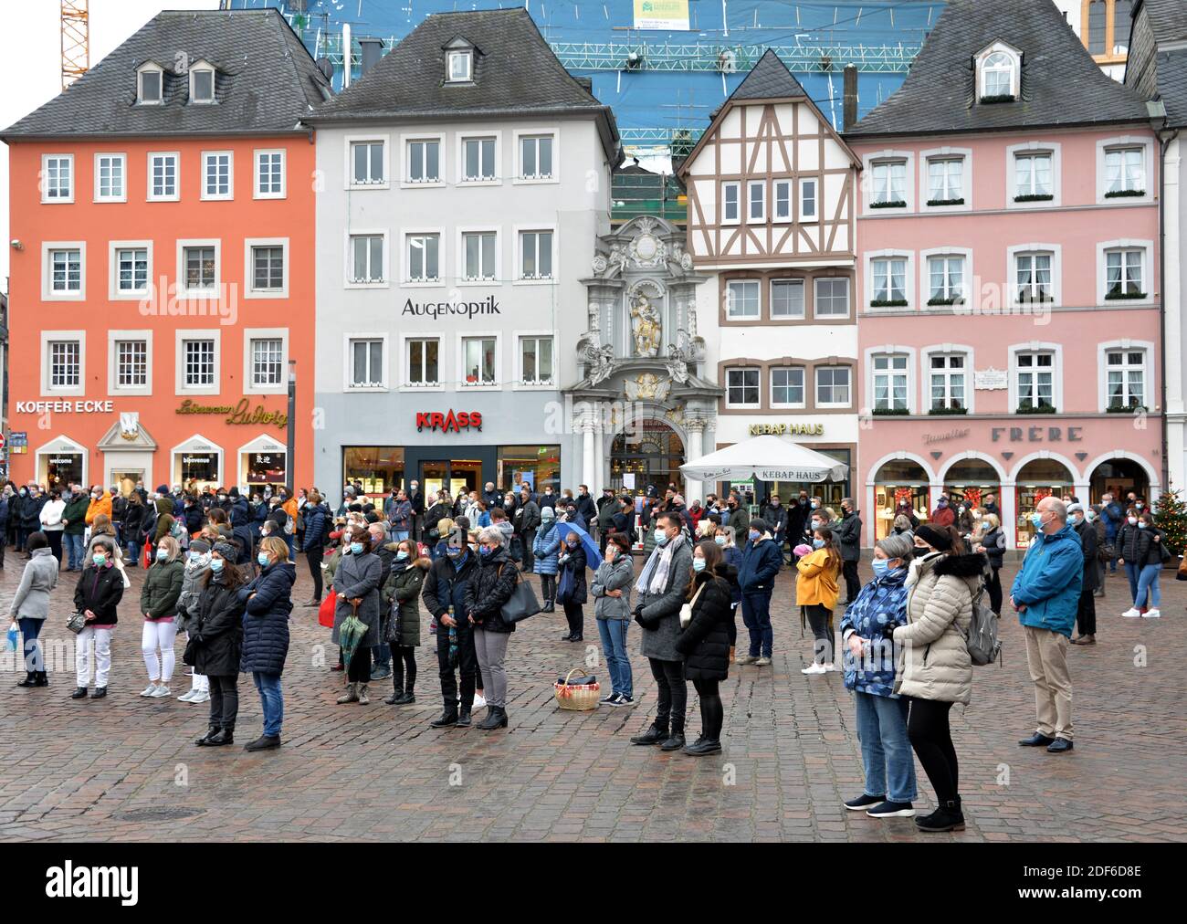 Trier, Germany. 03rd Dec, 2020. People stand in a minute's silence in  memory of the victims after the Trier amok drive with dead and injured  people at exactly the time a 51-year-old