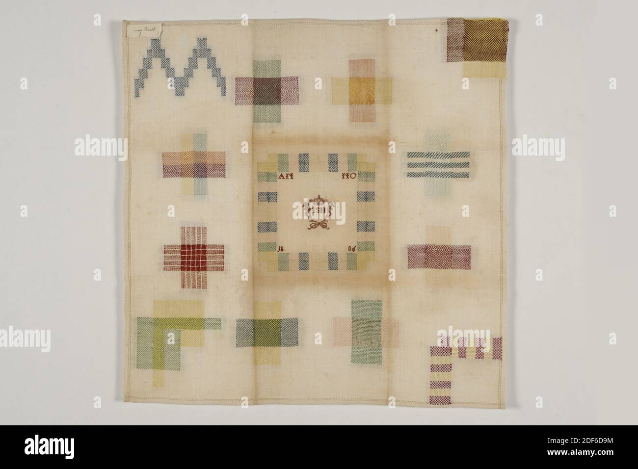 stopper, Anonymous, 1806, cotton, silk, General: 45 x 44.5cm (450 x 445mm), Cotton muslin stopper, tucked and embroidered with silk thread. With from left to right and from top to bottom: two stepped gables in doorstop, a cross stop in pointed twill and plain weave, a corner stop with selvedge, a cross stop in check twill and in plain weave with checkered pattern. The center panel is in twill with AN NO 18 06 in the center section in the corners and the center panel with JSH in the center. To the right of this a cross-stop with herringbone in stripe pattern and in diamond twill Stock Photo