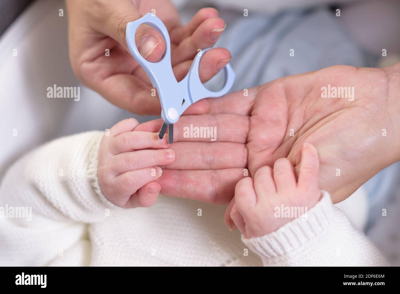Mother caring for newborn nails. Affection, happiness, child care, newborn baby image Stock Photo