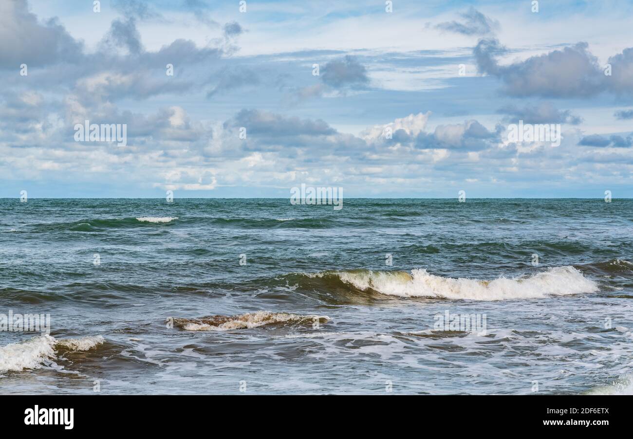 Tropical beach, small waves and blue sky with clouds Stock Photo - Alamy