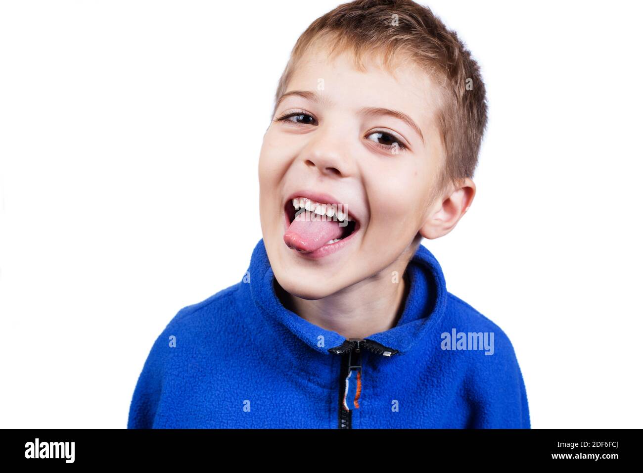 Portrait of difficult boy shows tongue isolated on a white. Stock Photo