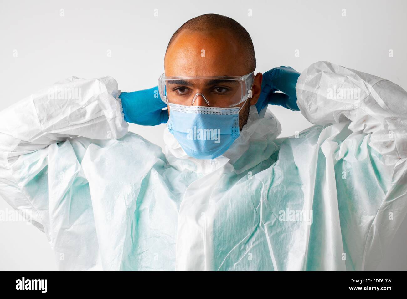 African american man doctor in medical protective gown and mask on ...