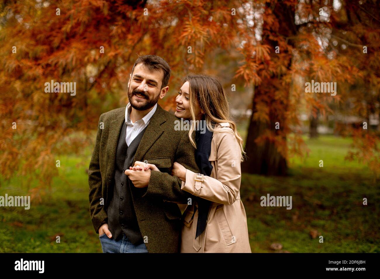 Handsome young couple in the autumn park Stock Photo - Alamy