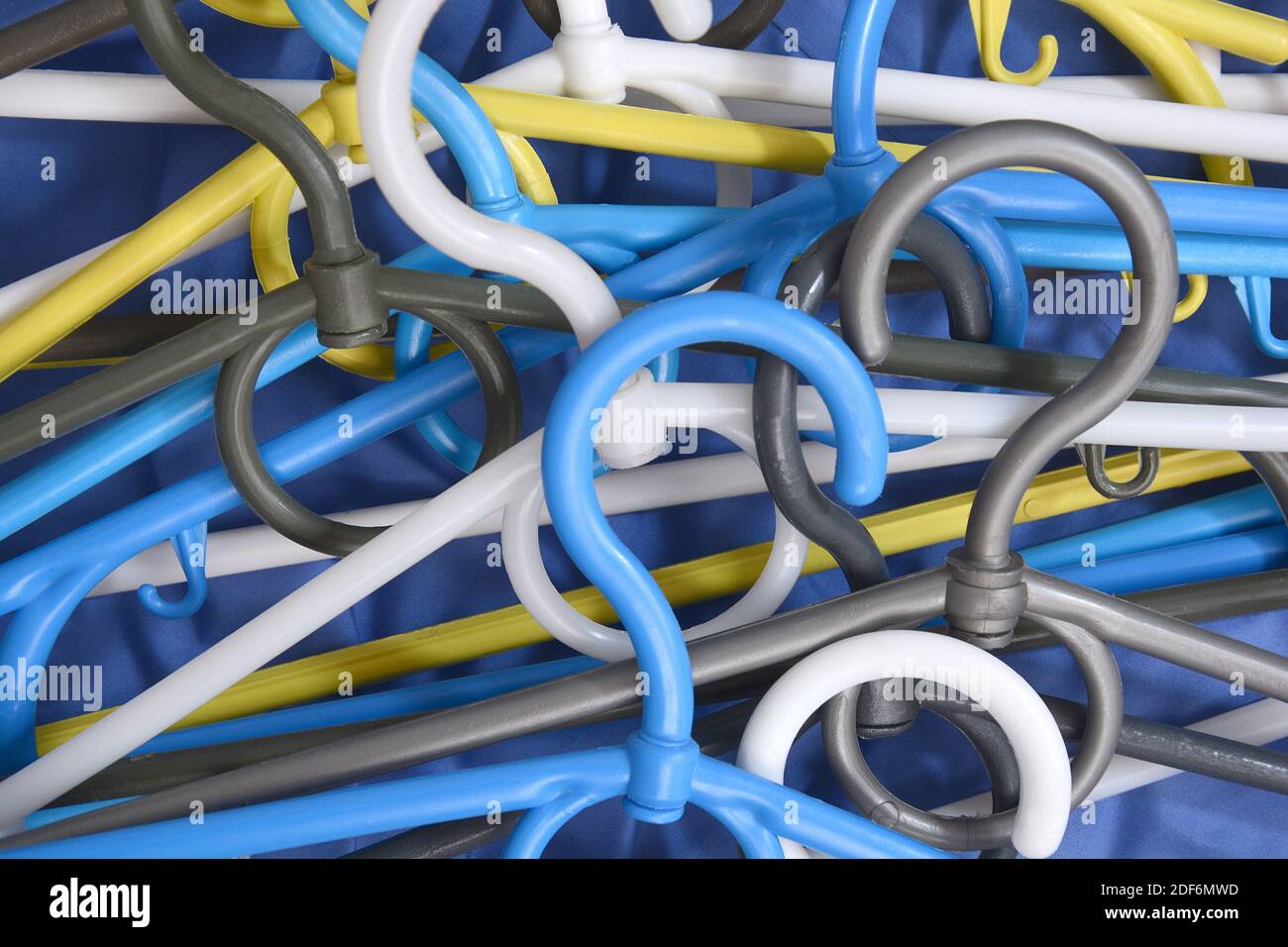 Many clothes hanger. Trempel on a blue background. Store concept for sale, design. Empty hanger set. Stock Photo