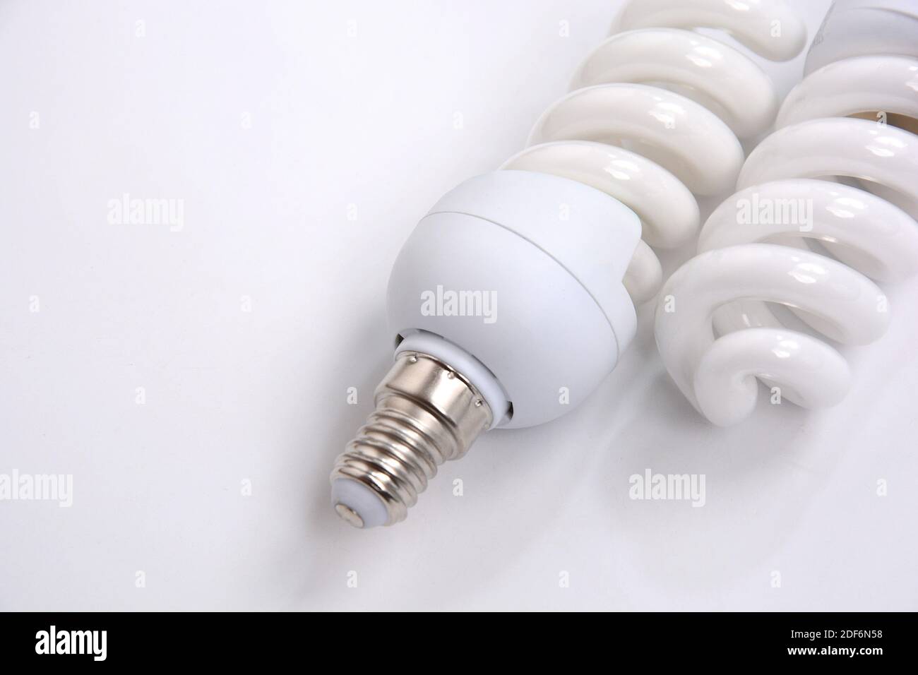Fluorescent Lightbulbs. Two compact fluorescent light bulb over white background. Stock Photo
