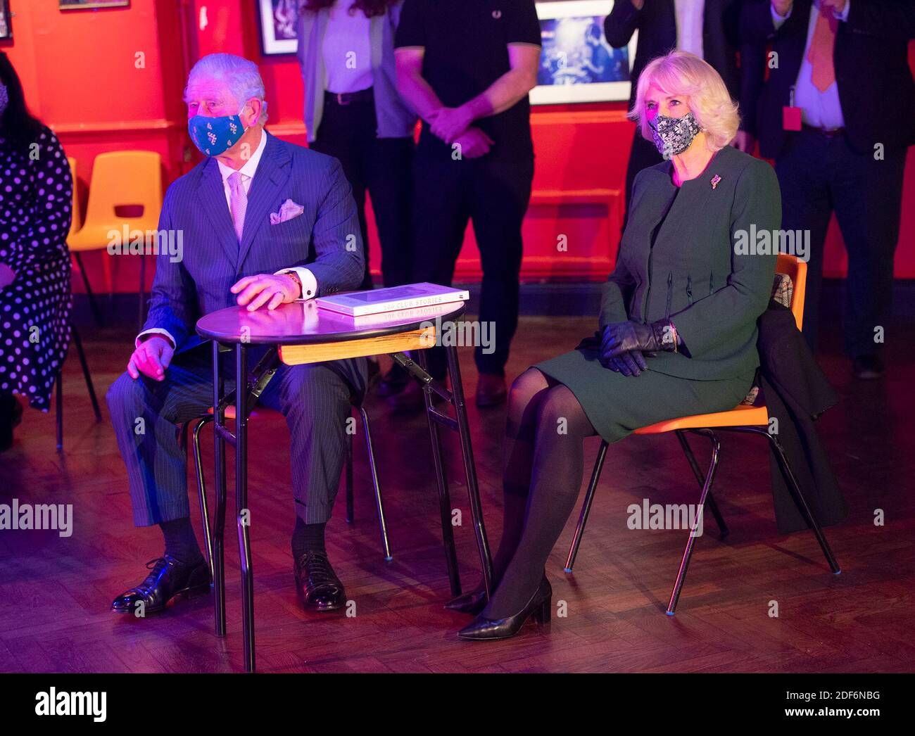 The Prince of Wales and Duchess of Cornwall watching a short musical performance by singer Emily Capell during a visit to the 100 Club nightclub in London. Stock Photo
