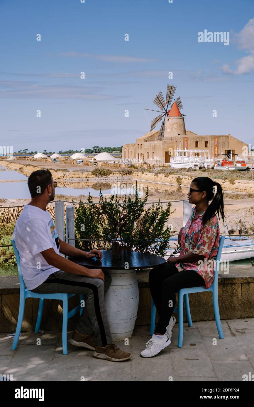 Salt Pans near Marsala, Sicily at Italy in Europe, couple visit Marsala Sicilia Stock Photo