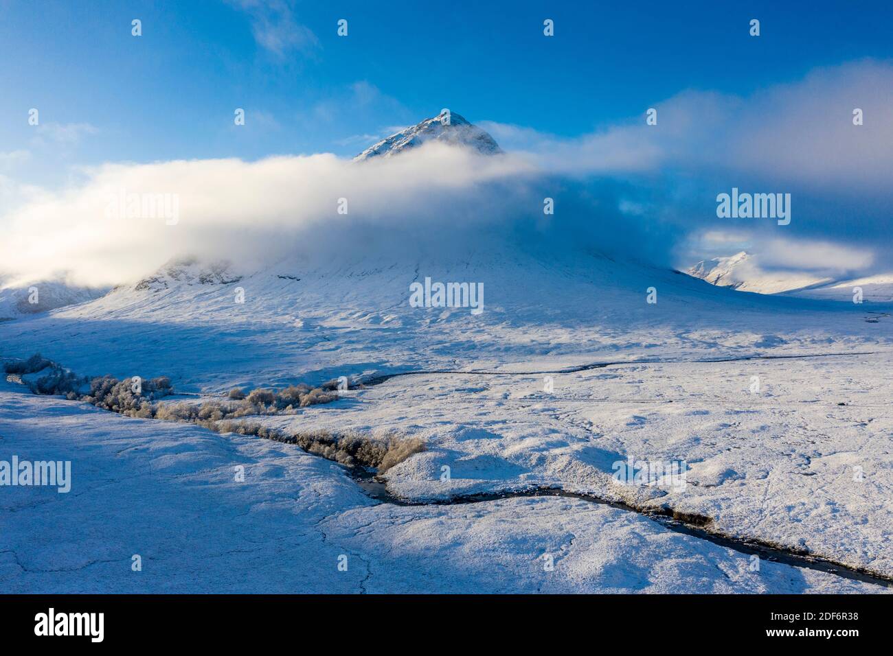 Glen Coe, Scotland, UK. 3 December 2020. A cold front has brought the first snowfall to the Scottish Highlands. Rannoch Moor and Glen Coe are covered in several inches of snow. Bright sunshine throughout the day created beautiful winter landscapes.  Pictured; Buachaille Etive Mor  shrouded in mist.  Iain Masterton/Alamy Live News Stock Photo