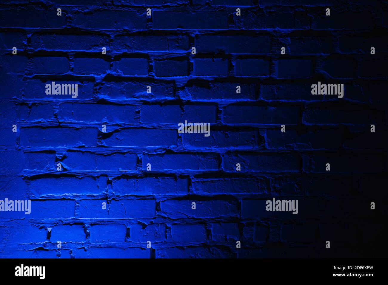 Empty brick wall with bright blue neon light background Stock Photo - Alamy
