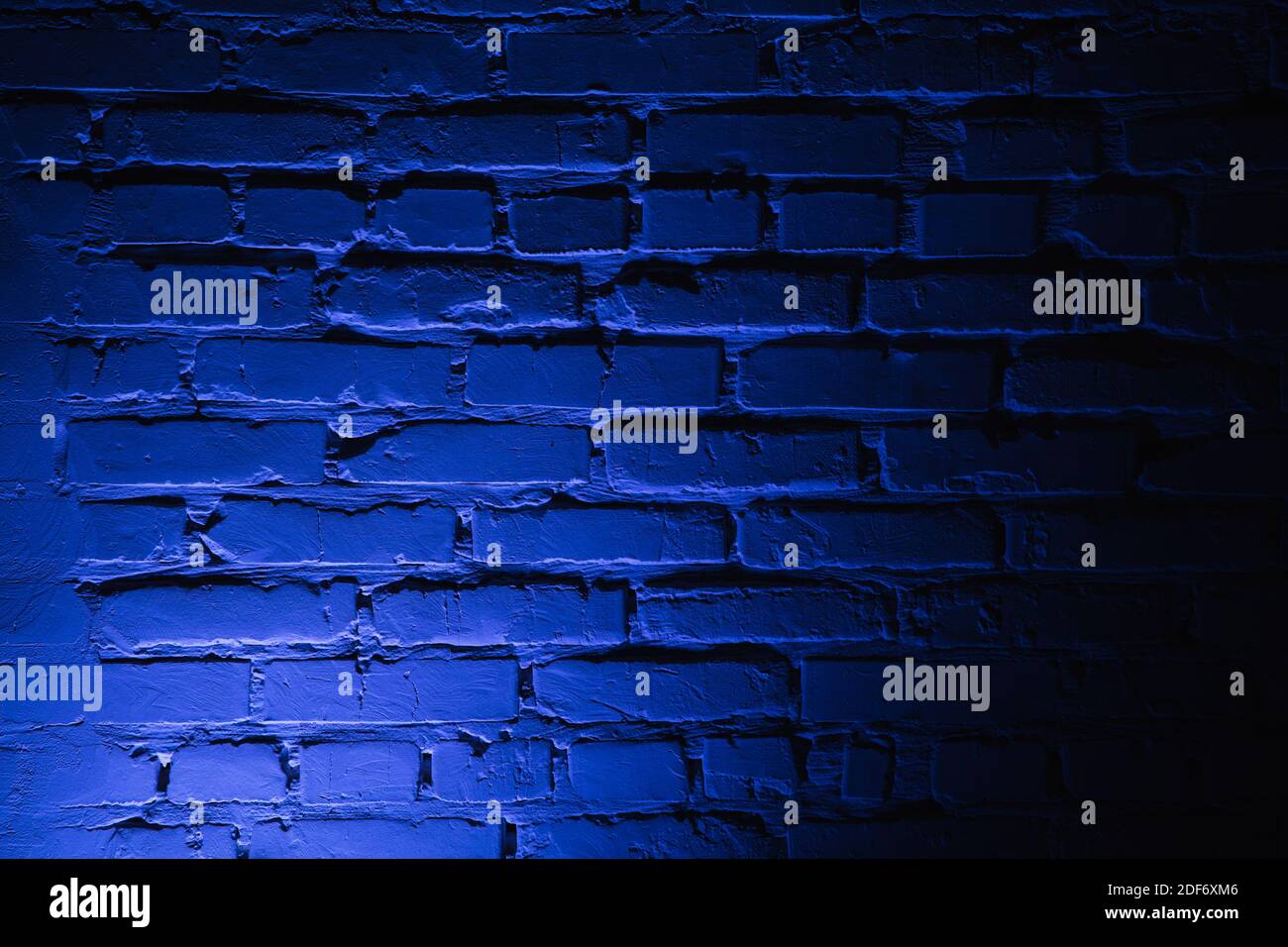 Empty brick wall with bright blue neon light background Stock Photo - Alamy