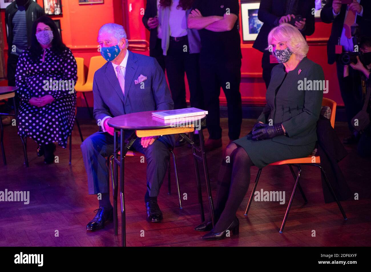 The Prince of Wales and Duchess of Cornwall watching a short musical performance by singer Emily Capell during a visit to the 100 Club nightclub in London. Stock Photo