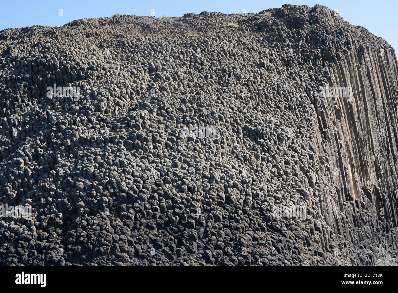 Columnar basalt. Basalt is an extrusive igneous rock. This photo was taken in Glaronissia Islet, Milos Island, Greece. Stock Photo