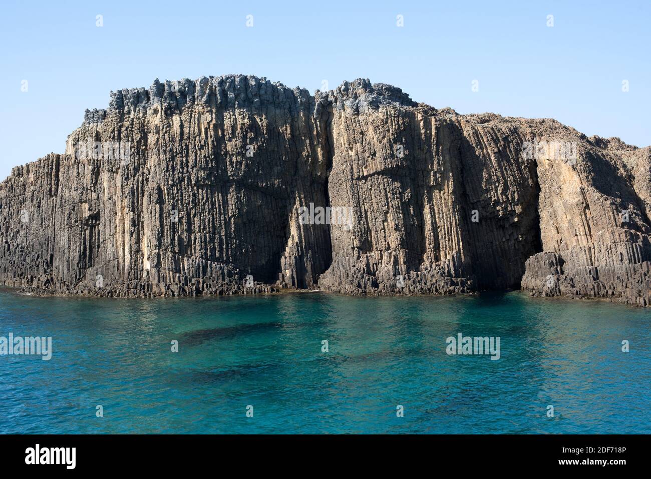 Columnar basalt. Basalt is an extrusive igneous rock. This photo was taken in Glaronissia Islet, Milos Island, Greece. Stock Photo
